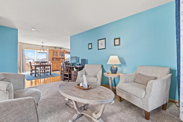 living area featuring baseboards and a textured ceiling