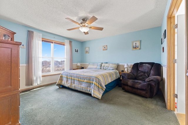 bedroom with carpet, ceiling fan, and a textured ceiling