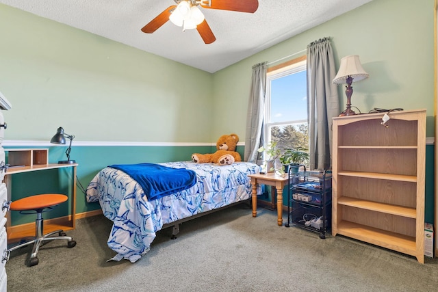 bedroom with carpet floors, ceiling fan, and a textured ceiling