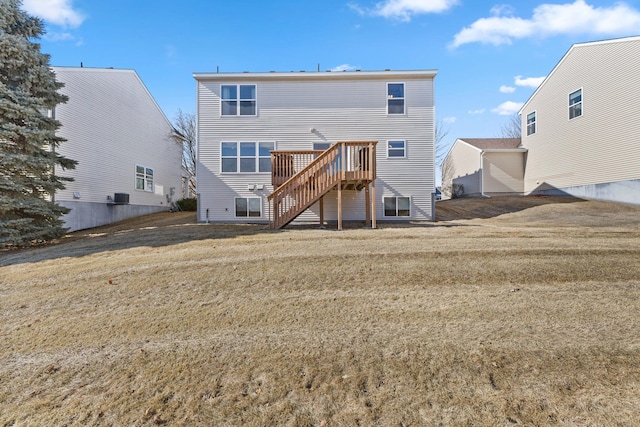 back of property with a lawn and stairway