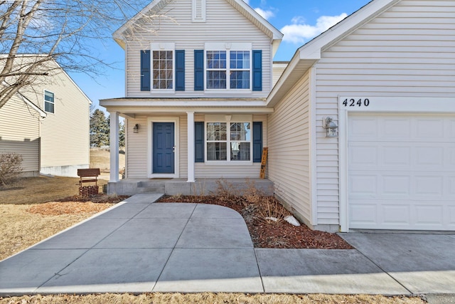 traditional-style house featuring a garage and covered porch