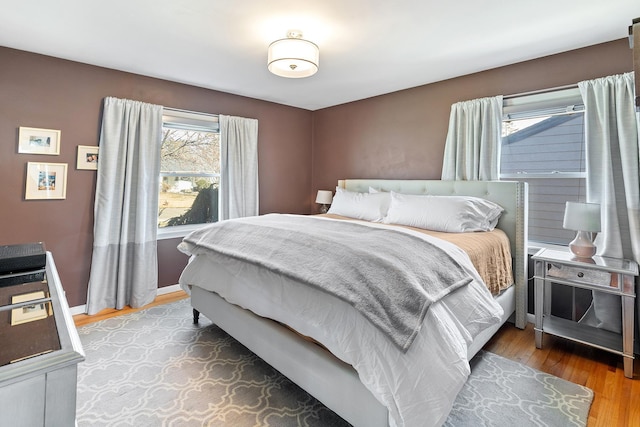 bedroom with wood finished floors and baseboards