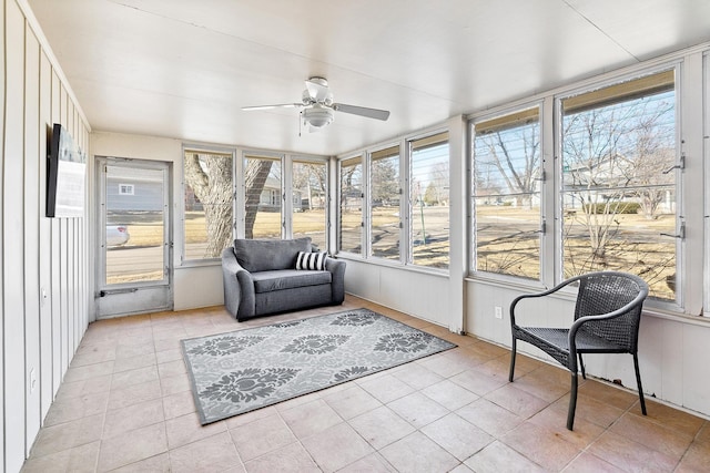 sunroom / solarium featuring a ceiling fan and a wealth of natural light