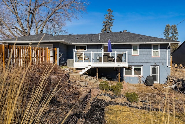 rear view of house featuring stairs, a deck, and fence