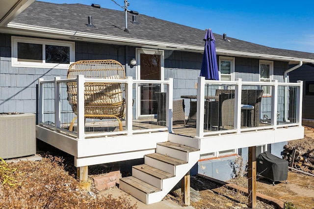 wooden terrace with cooling unit and grilling area