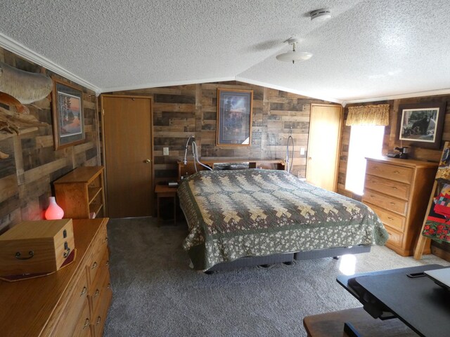 bedroom with vaulted ceiling, a textured ceiling, dark carpet, and wood walls