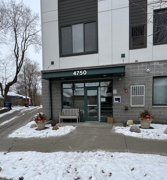 view of snow covered property entrance