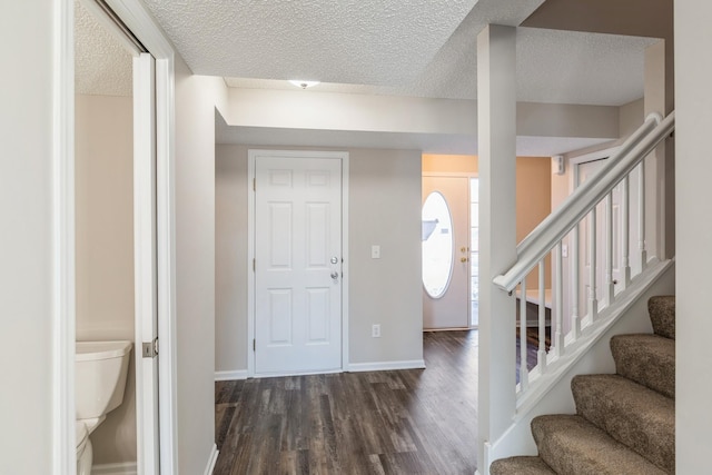 entrance foyer featuring dark wood-type flooring and a textured ceiling