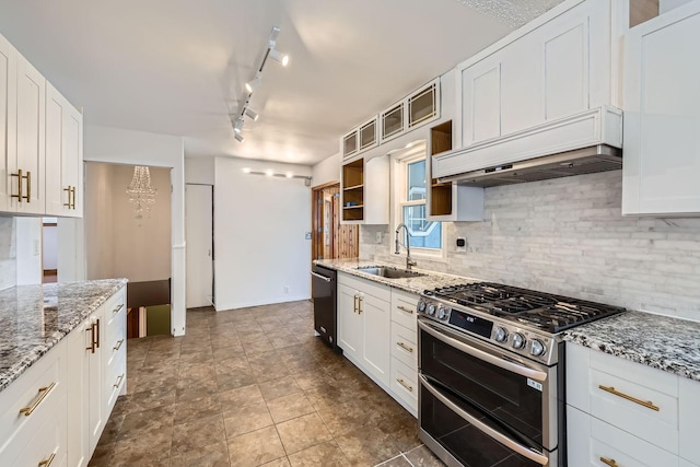 kitchen with sink, light stone countertops, white cabinets, custom exhaust hood, and range with two ovens