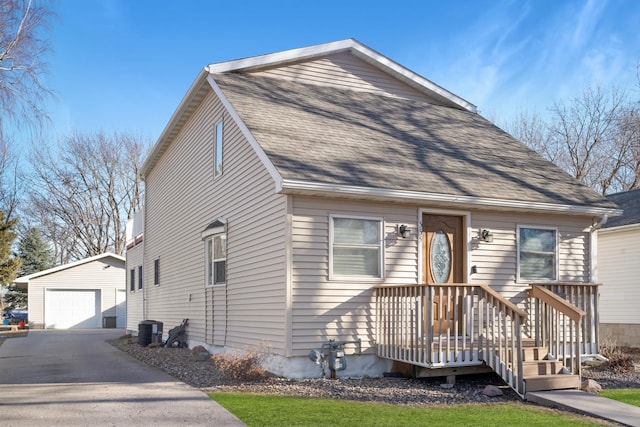 view of front of house featuring an outbuilding, a garage, and central air condition unit