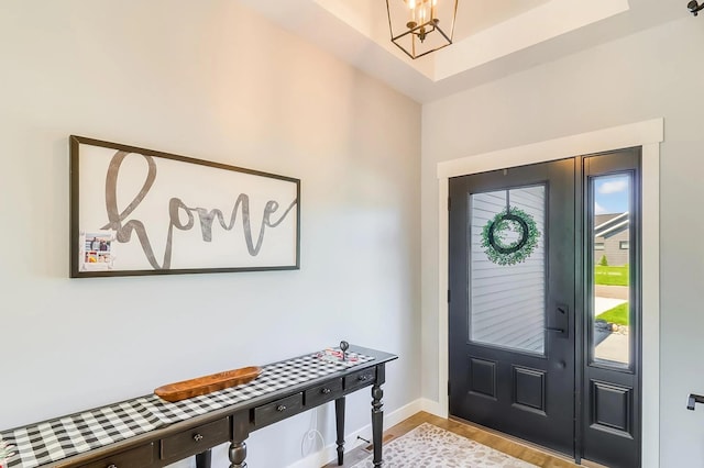 foyer with an inviting chandelier and light hardwood / wood-style floors