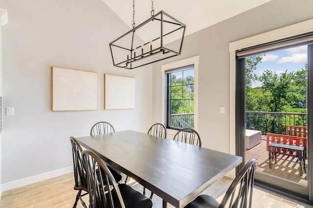 dining room featuring a notable chandelier and light hardwood / wood-style flooring