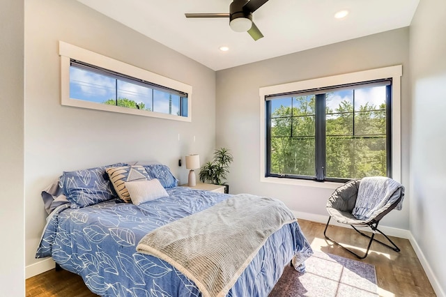 bedroom with hardwood / wood-style floors and ceiling fan