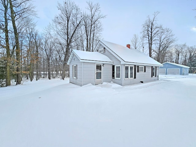 view of front of home featuring a garage and an outdoor structure