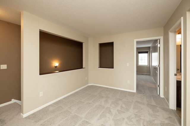 carpeted spare room with a textured ceiling