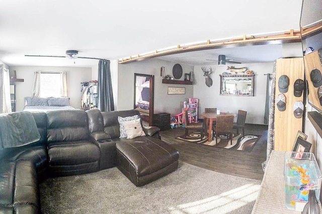 living room featuring wood-type flooring and ceiling fan