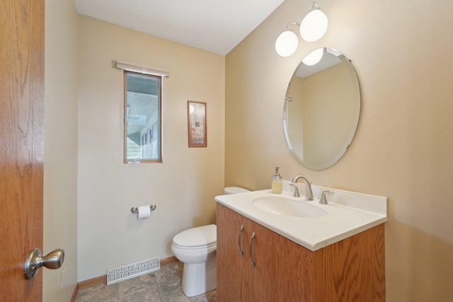 bathroom with toilet, baseboards, visible vents, and vanity