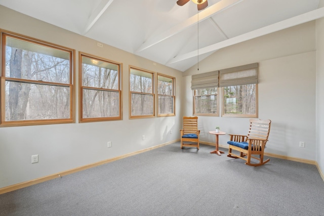 living area with carpet floors, vaulted ceiling with beams, and baseboards