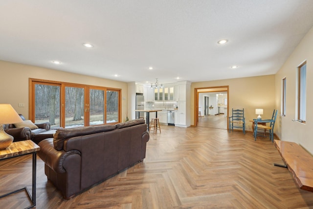 living area with a notable chandelier, french doors, and recessed lighting