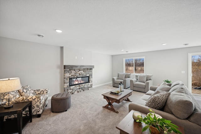 living room featuring light colored carpet, a textured ceiling, and a fireplace