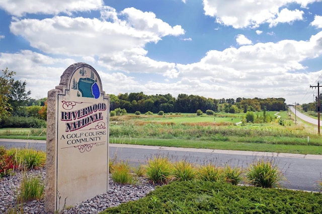 community / neighborhood sign with a rural view