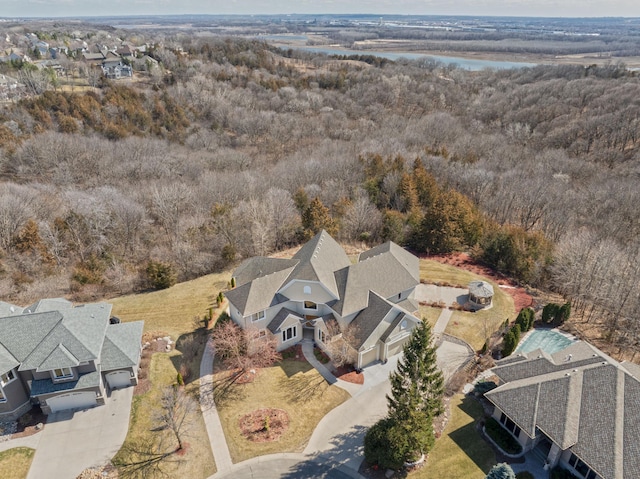 birds eye view of property featuring a residential view, a view of trees, and a water view