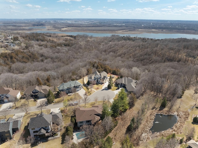 birds eye view of property featuring a residential view, a view of trees, and a water view
