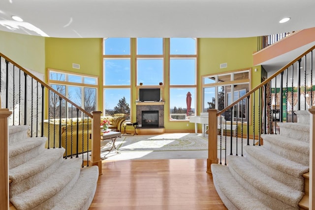 living area with a towering ceiling and stairs