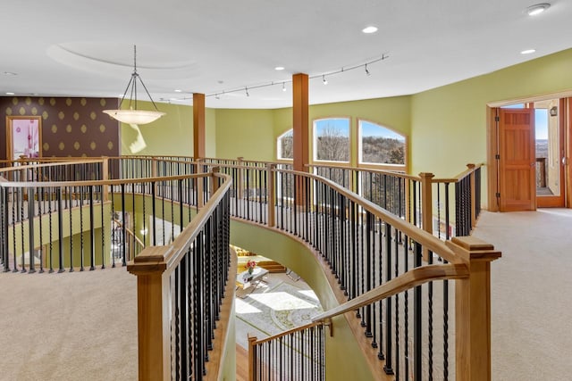 staircase featuring a healthy amount of sunlight and carpet flooring