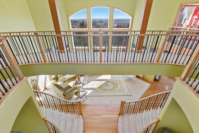dining area with wood finished floors, a wealth of natural light, and stairs