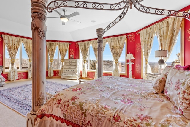 bedroom featuring lofted ceiling, carpet flooring, and multiple windows