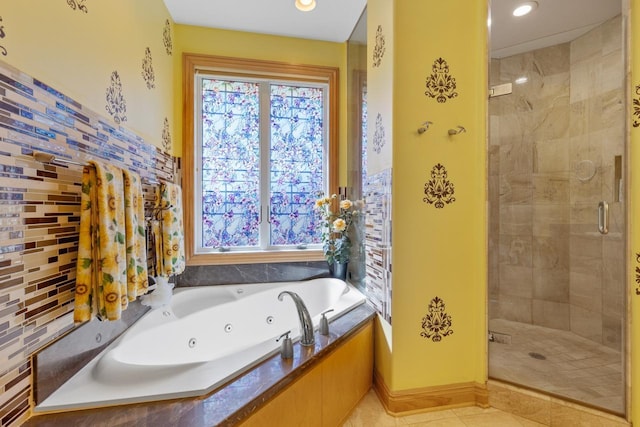 bathroom featuring recessed lighting, a healthy amount of sunlight, a whirlpool tub, and a stall shower