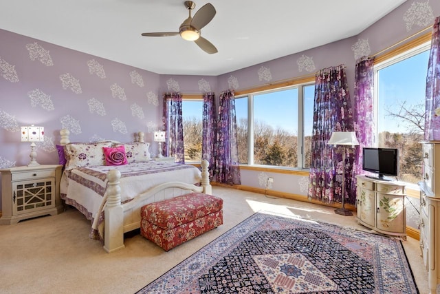 carpeted bedroom featuring wallpapered walls, a ceiling fan, and baseboards