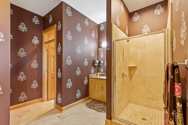 full bathroom with baseboards, a shower stall, tile patterned flooring, and vanity