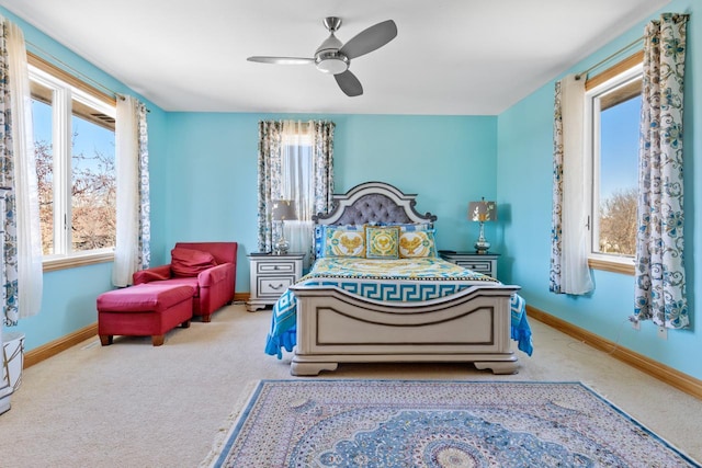 carpeted bedroom featuring baseboards and ceiling fan