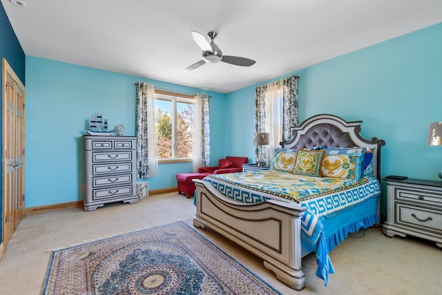 carpeted bedroom with a ceiling fan and baseboards