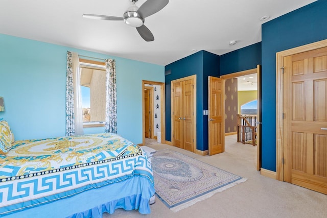 carpeted bedroom with a closet, baseboards, and ceiling fan