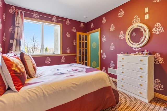 bedroom with carpet floors, visible vents, and baseboards