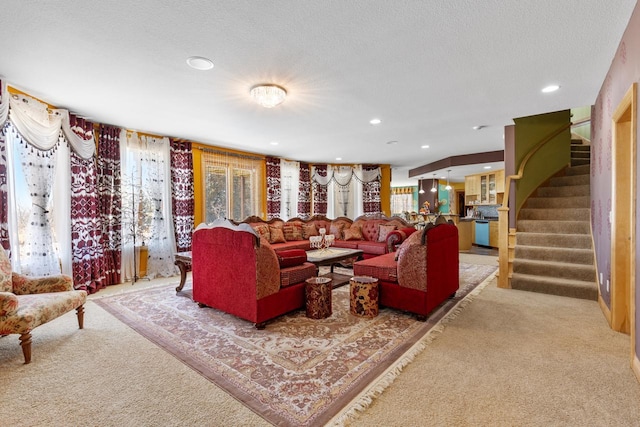 carpeted living room with stairs, a textured ceiling, and recessed lighting