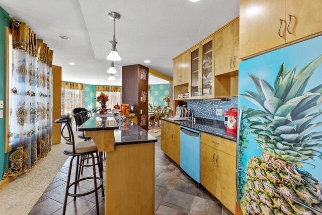 kitchen featuring a center island, a breakfast bar, glass insert cabinets, dishwashing machine, and recessed lighting