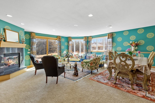 living room featuring carpet floors, a tile fireplace, and a wealth of natural light