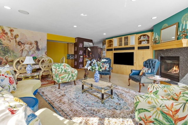 living area with a high end fireplace, carpet floors, and recessed lighting