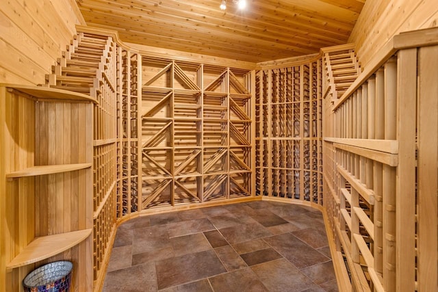 wine cellar featuring wooden ceiling and stone finish flooring
