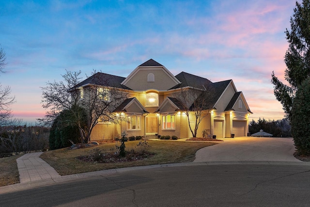 view of front facade featuring stucco siding, an attached garage, and concrete driveway