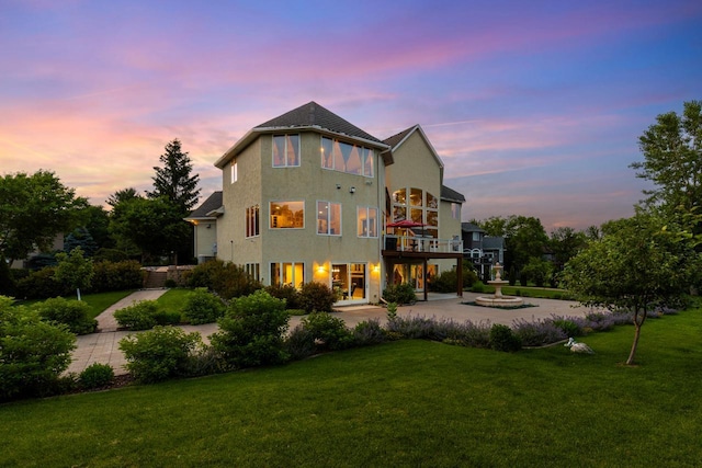19115 Vogel Farm Trl, Eden Prairie, MN 55347 - rear view of house featuring a yard, stucco siding, a carport, and driveway
