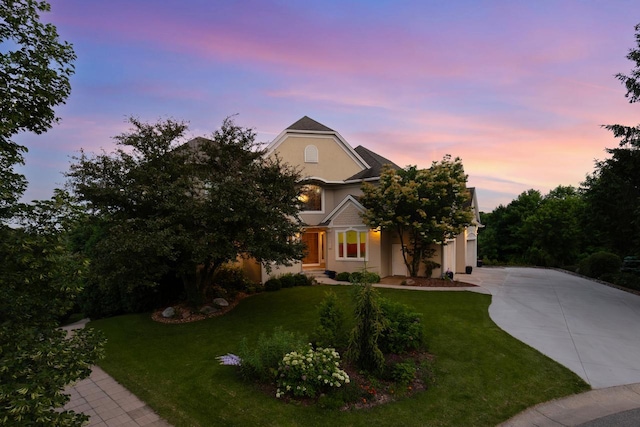 19115 Vogel Farm Trl, Eden Prairie, MN 55347 - view of property hidden behind natural elements featuring concrete driveway, a front lawn, stucco siding, and a garage