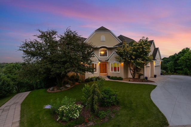 19115 Vogel Farm Trl, Eden Prairie, MN 55347 - view of front facade featuring concrete driveway, stucco siding, and a lawn