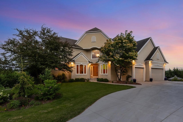 19115 Vogel Farm Trl, Eden Prairie, MN 55347 - view of front of property with driveway, a lawn, a garage, and stucco siding