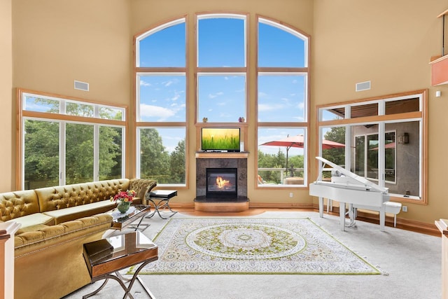 19115 Vogel Farm Trl, Eden Prairie, MN 55347 - carpeted living area with a high ceiling and a tile fireplace