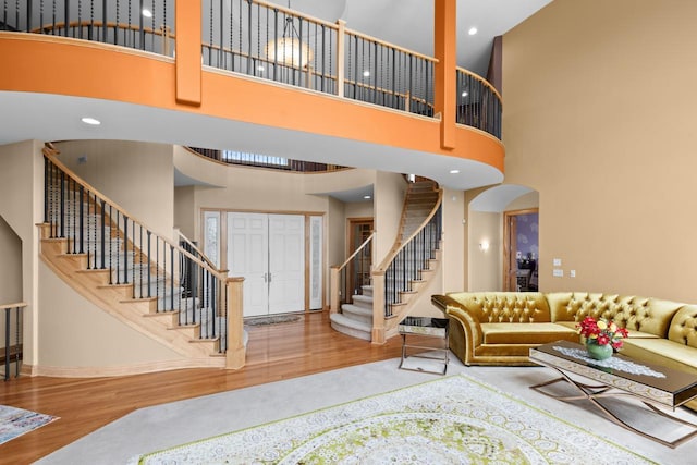19115 Vogel Farm Trl, Eden Prairie, MN 55347 - living room featuring a towering ceiling, stairs, and wood finished floors